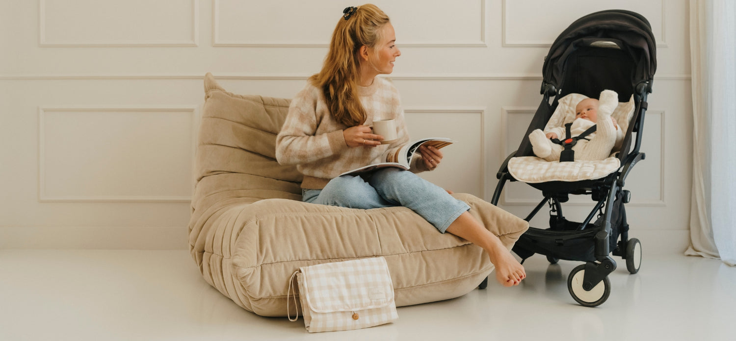 maman avec bébé montrant le matelas de poussette et le matelas à langer motif vichy de tapilou